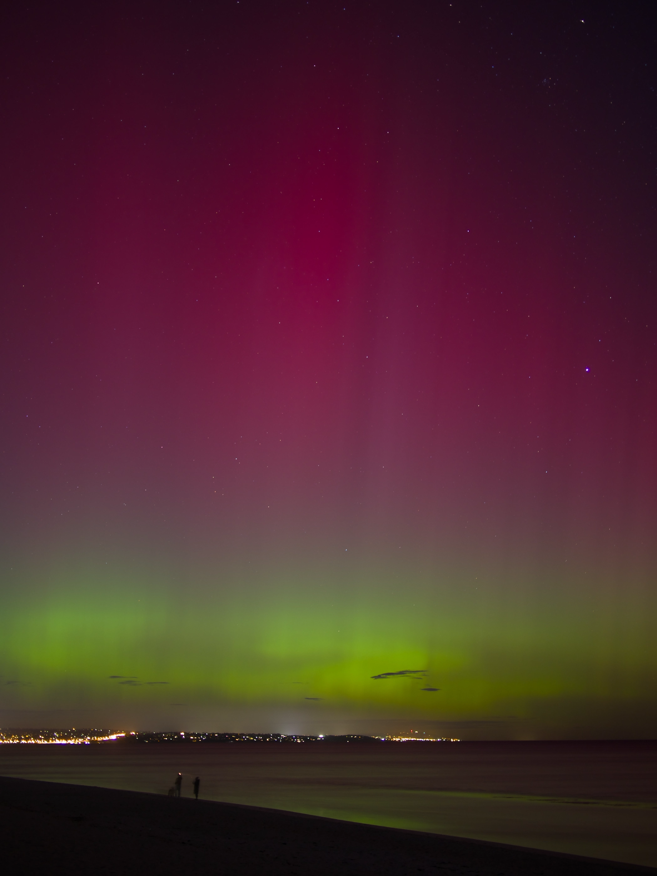 The sky at night painted in red and green colours.